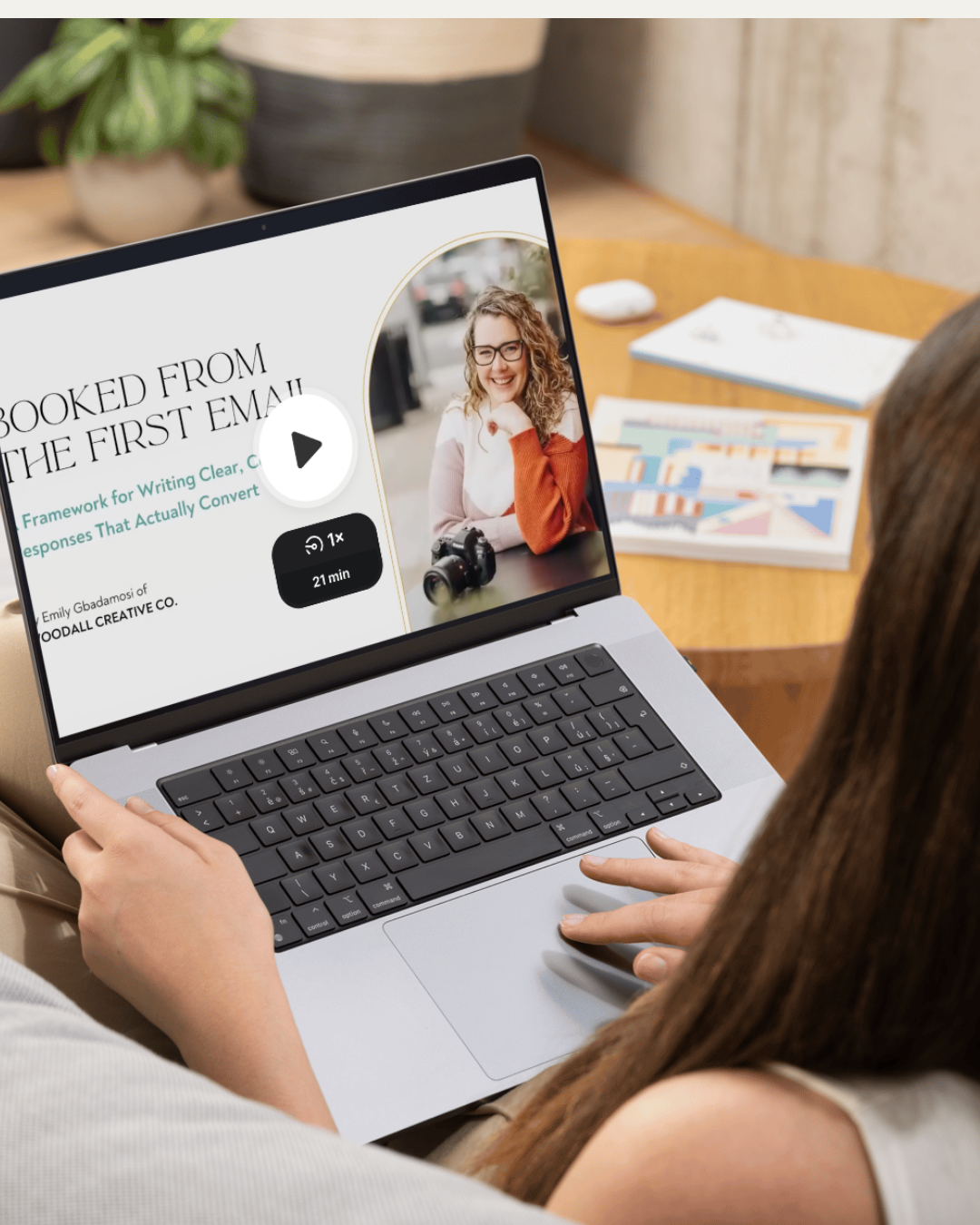 Woman looks at screen with video of Booked From The First Email Video Course